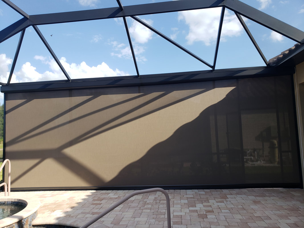 A patio covered in a shade next to a swimming pool