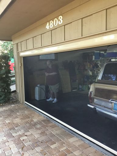 A car parked in front of a garage door