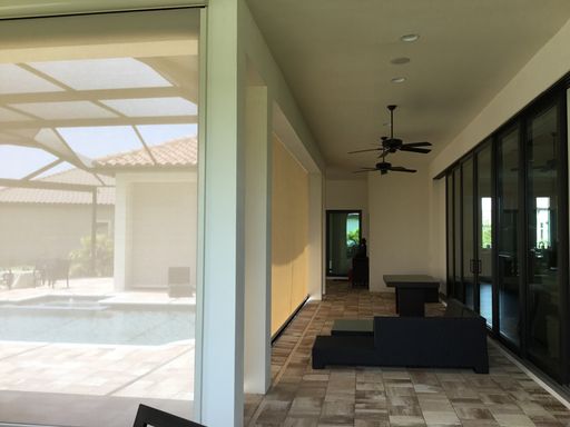 A room with a ceiling fan and a tiled floor