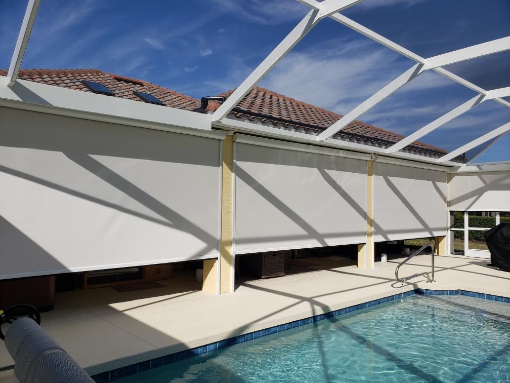 A swimming pool with a sun shade covering it