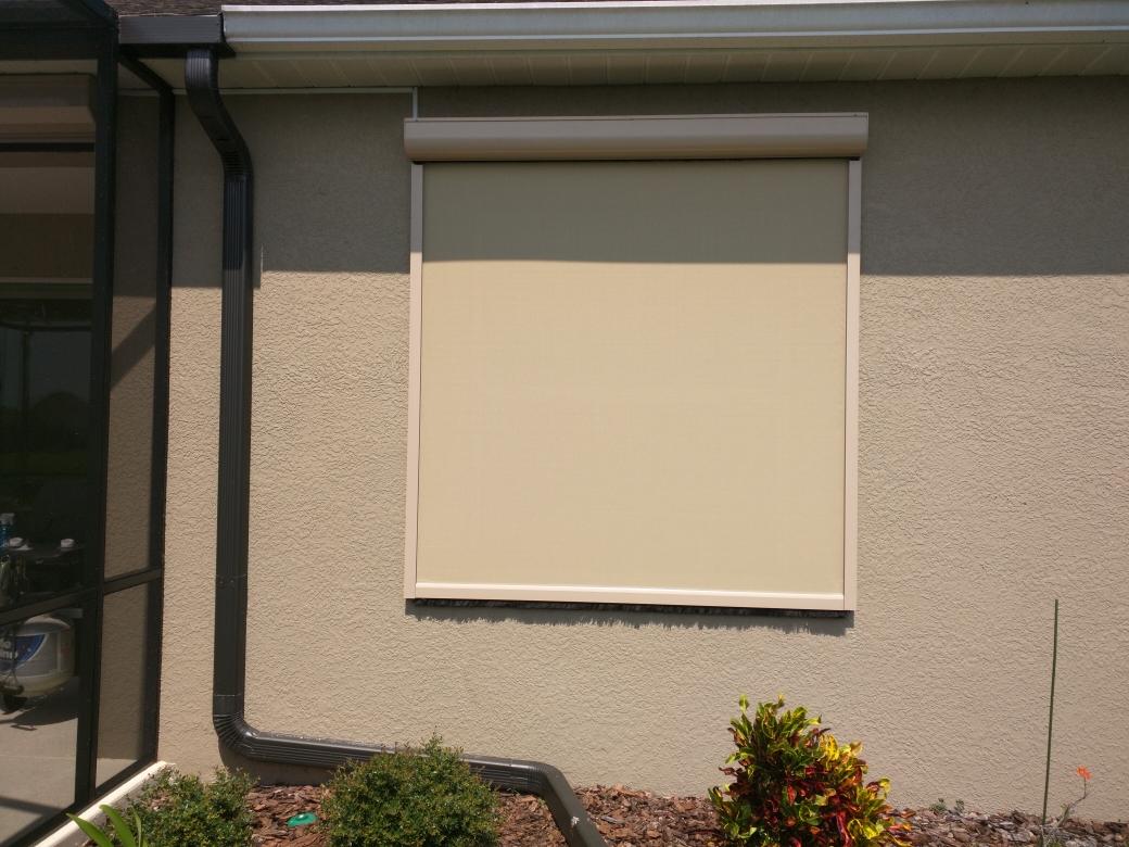 A window with a roller shade on the outside of it