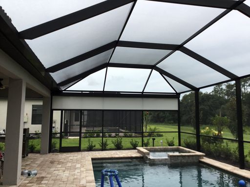 A pool inside of a house with a glass roof