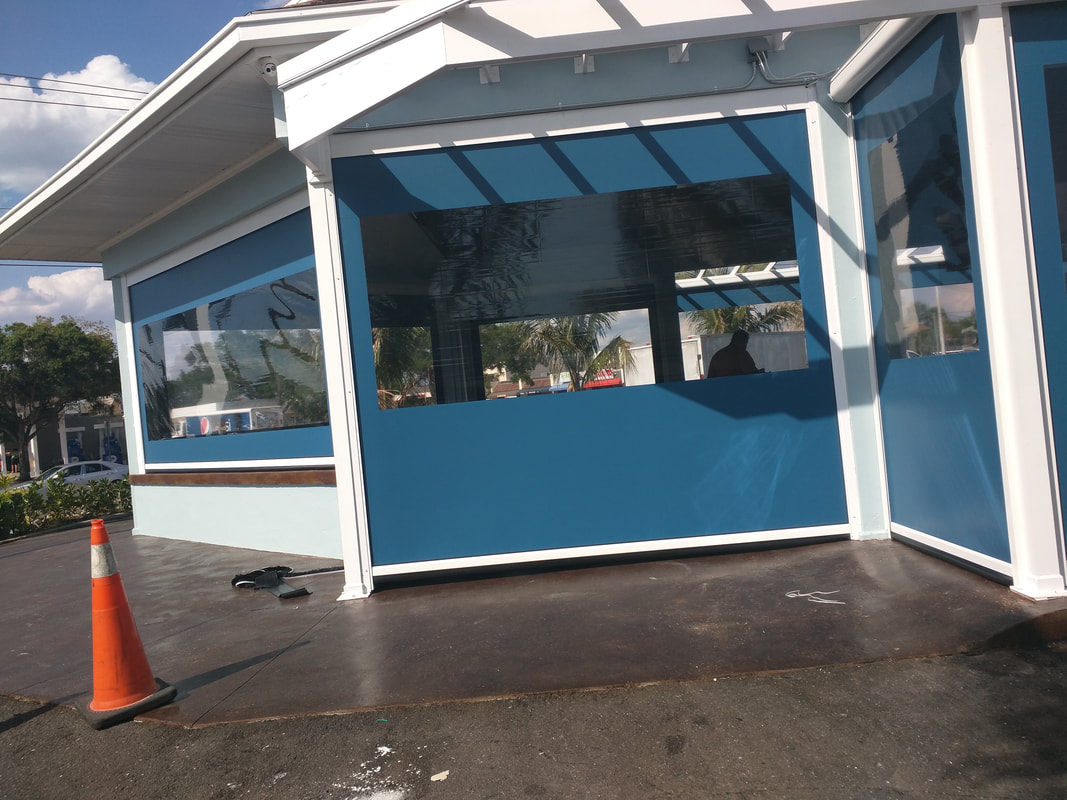 A blue and white building with a cone in front of it